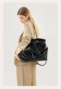 Black leather shoulder tote bag detail showing large capacity, soft texture and chic design.