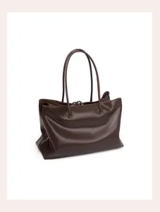 Leather tote bag detail showing premium brown texture and double top handles for daily use.