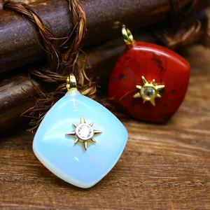 Detailed shot of rhombus crystal pendants featuring gold sunburst and sparkling rhinestones.