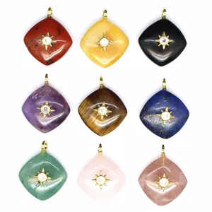 Detail view of various natural stone rhombus crystal pendants with gold star settings for jewelry making.