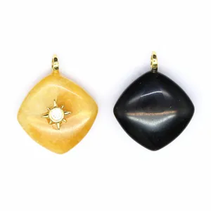 Close-up of diamond-shaped natural stone crystal pendants with gold loops and star charm.