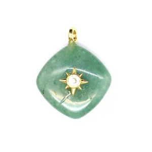 Closeup of green crystal rhombus pendant with gold sun inlay detail for jewelry making.