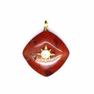 Red stone rhombus crystal pendant detail featuring a gold sunburst design with clear stone.