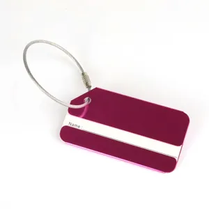 Aluminum metal luggage tag detail, steel wire loop, blank name card slot, durable travel ID.
