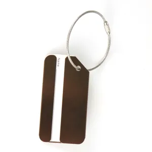 Aluminum alloy metal luggage tag detail view with steel wire loop and name label area.