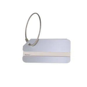 Closeup of silver aluminum luggage tag with steel wire loop, durable ID name tag for travel bags.