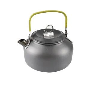Detailed view of portable outdoor camping kettle in dark gray finish with green handle.