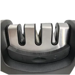Kitchen knife sharpener detail view, multi-function tool with three sharpening slots.