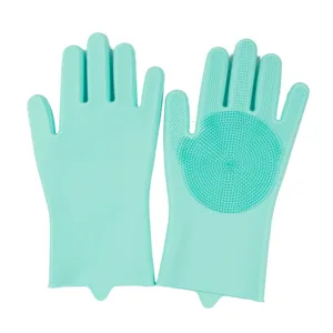 Detail shot of mint green silicone cleaning gloves with dense scrubbing bristles for kitchen use.