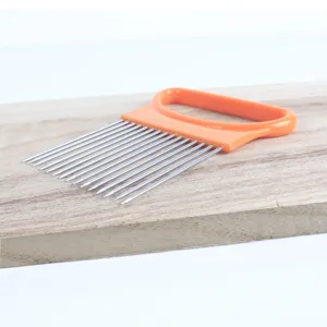 Stainless steel onion holder and meat tenderizer needle detail shot with orange handle.