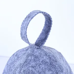 Gray felt sauna hat top hanging loop detail shot showing fine wool texture and neat stitching.