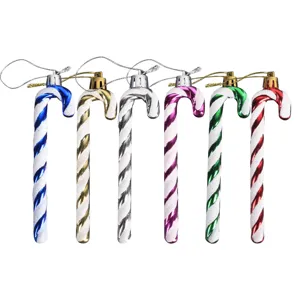 Detail view of colorful plastic Christmas candy cane ornaments with glitter stripes for tree dec.