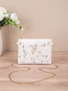 White women shoulder bag with floral embroidery, butterfly decor and gold chain strap.