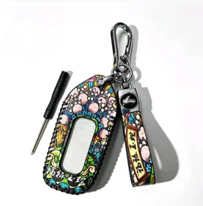 Detailed view of Chinese style zodiac snake car key case and strap with metal hardware.