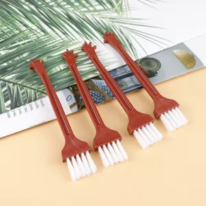 Mini plastic keyboard cleaning brush set with white bristles and cute handle for small gaps.