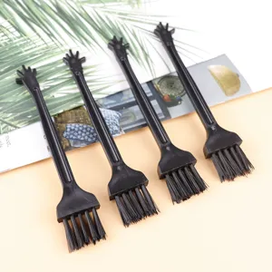Mini black plastic cleaning brush for keyboard and small appliances, durable bristle design.