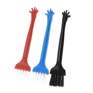 Mini plastic cleaning brush detail showcasing hand shaped handle and soft bristles.