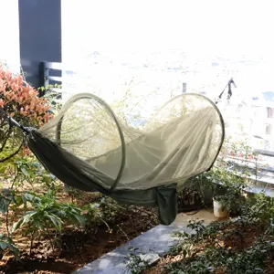 Outdoor mosquito net hammock scene detail showing portable camping mesh design and support rods.
