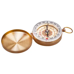 Detailed close-up of vintage brass pocket compass, antique flip cover design with clear dial.