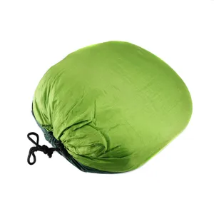 Detail view of durable green nylon hammock compression stuff sack with black drawcord.