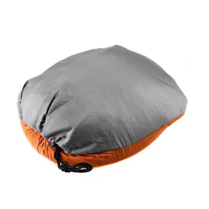 Portable camping hammock packed in storage bag detail, lightweight outdoor gear display.