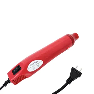 Mini electric heat gun nozzle detail showing safety warning and power specification label.