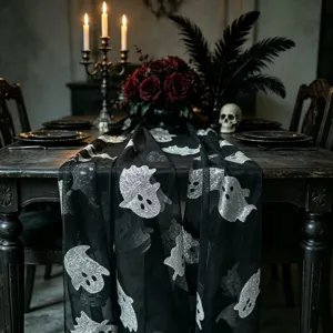 Halloween black mesh table runner with silver glitter ghost pattern for party decor.