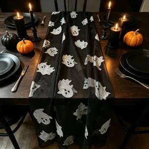 Halloween black mesh table runner with silver glitter ghost pattern for party decor detail shot.