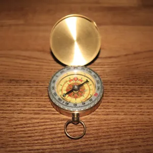 Vintage solid brass pocket compass with flip cover outdoor hiking navigation tool dial.