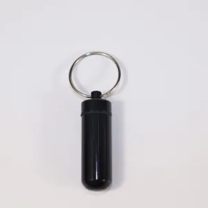 Black aluminum waterproof pill fob capsule container with portable keychain ring.