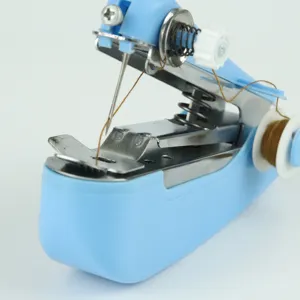 Portable handheld mini sewing machine detail shot showcasing metallic mechanism and thread spool.