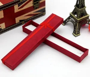Long red paper gift box with ribbon bow for necklace jewelry packaging, elegant presentation.