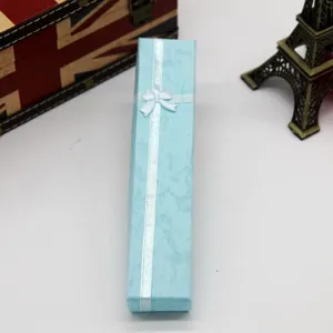 Light blue long gift box with white ribbon bow, elegant packaging for necklaces and jewelry.