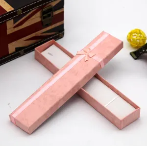 Pink rectangular paper gift box with ribbon bow, ideal for necklace and jewelry packaging detail.