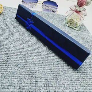 Dark blue long gift box with blue ribbon bow detail, perfect necklace and jewelry packaging.