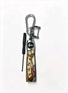 Detail view of the Chinese style metal and leather car keychain pendant with a mini screwdriver.