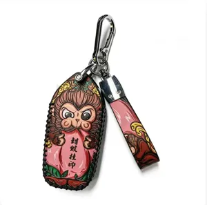Hand-carved leather monkey key cover detail showing exquisite tooling and stitching craftsmanship.