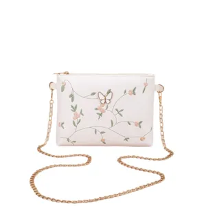 White embroidered women shoulder bag with butterfly accent and gold chain strap for daily style.