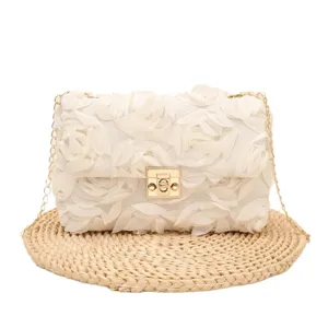 Elegant white floral evening crossbody bag with gold chain strap and metal lock closure main view