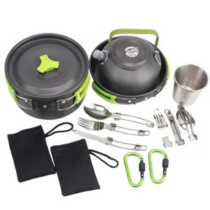Camping cookware set detail showing pots, kettle, cups, and cutlery for outdoor camping.