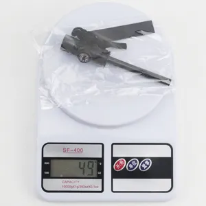 Survival fire starter with magnesium rod and compass, lightweight outdoor camping gear detail view.