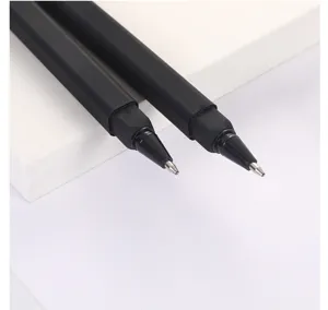Close-up detail of black square plastic ballpoint pen with sleek geometric barrel design.