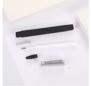 Detailed shot of disassembled square ballpoint pen components including refill, spring and cap.