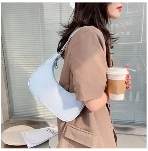 Light blue crescent shoulder hobo bag, stylish minimalist daily fashion accessory.