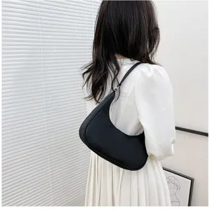 Detailed view of the black crescent underarm shoulder bag showcasing its sleek silhouette.