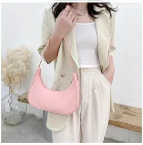 Pink nylon hobo shoulder bag detail, half-moon underarm purse design, casual daily style.