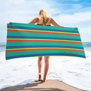 Detail view of microfiber beach towel with colorful stripes for adults, perfect for seaside swimming.