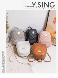 Detail shot of multi-color mini backpacks featuring quilted design and gold metal clasp.