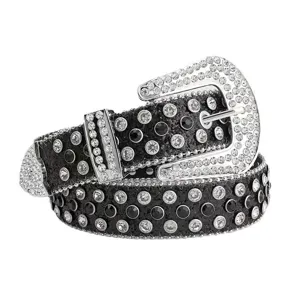 Close-up detail of a women's black leather belt sparkling with rhinestones and ornate metal buckle.