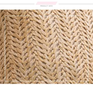 Close up detail of straw woven backpack fabric texture featuring natural woven herringbone pattern.